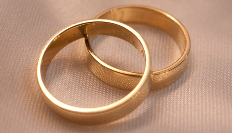 gold ring on white textile