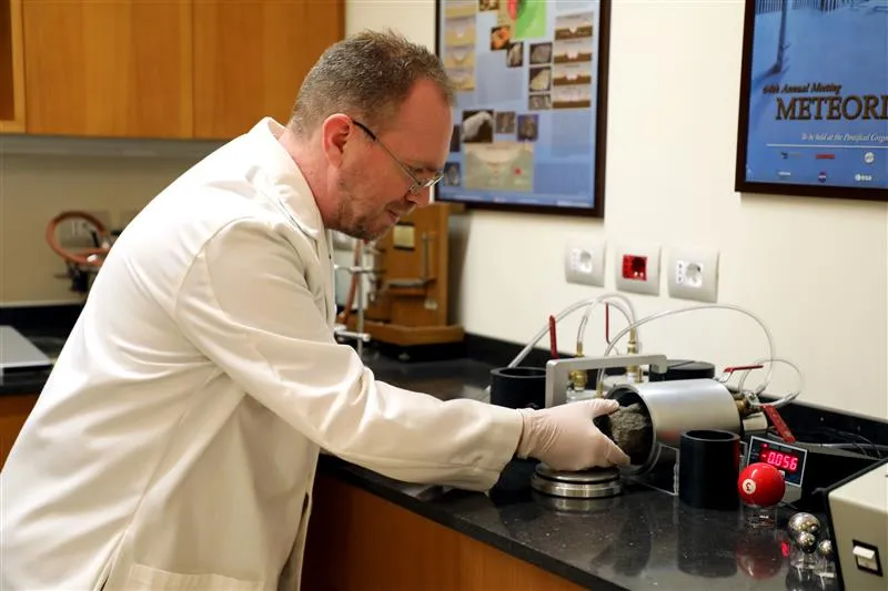 Brother Robert Macke, a Jesuit and astronomer at the Vatican Observatory, works in his office at the Vatican Observatory. Credit: Photo courtesy of Brother Robert Macke