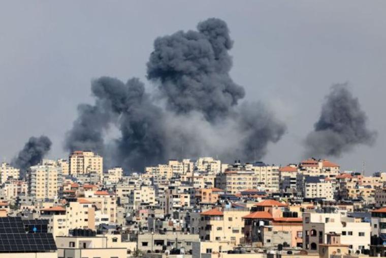 Smoke rises over Gaza City on Oct. 7, during Israeli airstrike. Palestinian militants have begun a ‘war’ against Israel, the country’s defense minister said on Oct. 7, after a barrage of rockets were fired and fighters from the Palestinian enclave infiltrated Israel, a major escalation in the Israeli-Palestinian conflict.