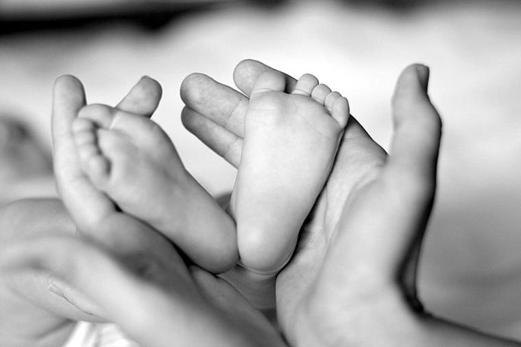 Baby feet in mother’s hands
