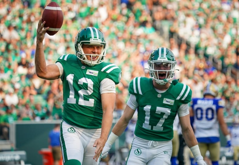Saskatchewan Roughriders kicker Brett Lauther (12) celebrates with teammate Jaxon Ford (17) after recovering an onside kick against Winnipeg Blue Bombers during the first half of CFL Labour Day Classic football action in Regina, Sunday, Sept. 3, 2023