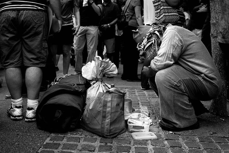 People in need wait outside the doors of a homeless shelter.
