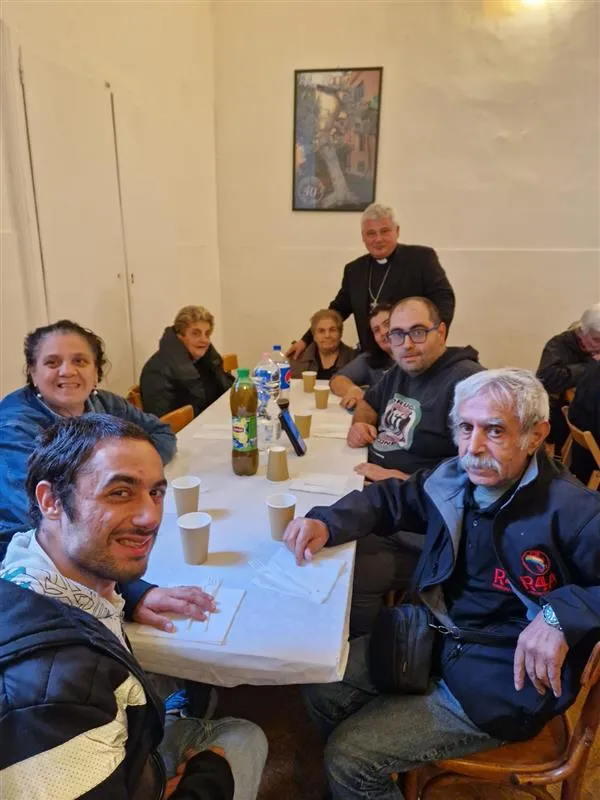 Cardinal Konrad Krajewski, papal almoner, joins future clients on the new papal laundromats for lunch. Credit: Holy See Press Office