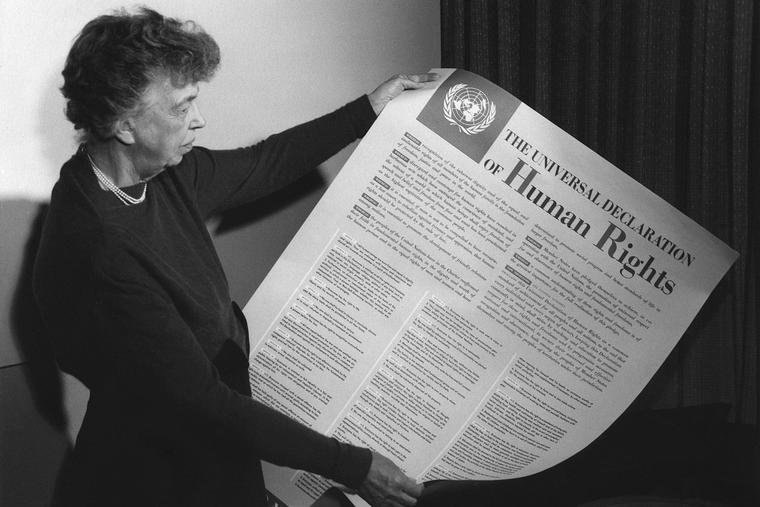 Eleanor Roosevelt holding poster of the Universal Declaration of Human Rights at Lake Success, New York in Nov., 1949.