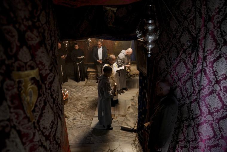 Priests pray at the Grotto, under the Church of the Nativity, traditionally believed to be the birthplace of Jesus Christ in the West Bank town of Bethlehem, Tuesday Dec. 19, 2023. World-famous Christmas celebrations in Bethlehem have been put on hold due to the ongoing Israel-Hamas war.