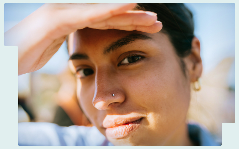 woman-shading-her-face-from-the-sun-with-hand