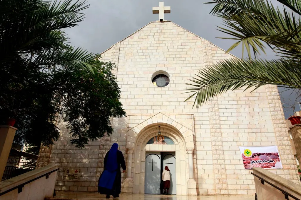 Worshippers arrive to attend Christmas Day Mass at the Roman Catholic Church of Holy Family in Gaza City on Dec. 25, 2017. Credit: Mohammed Abed/AFP via Getty Images