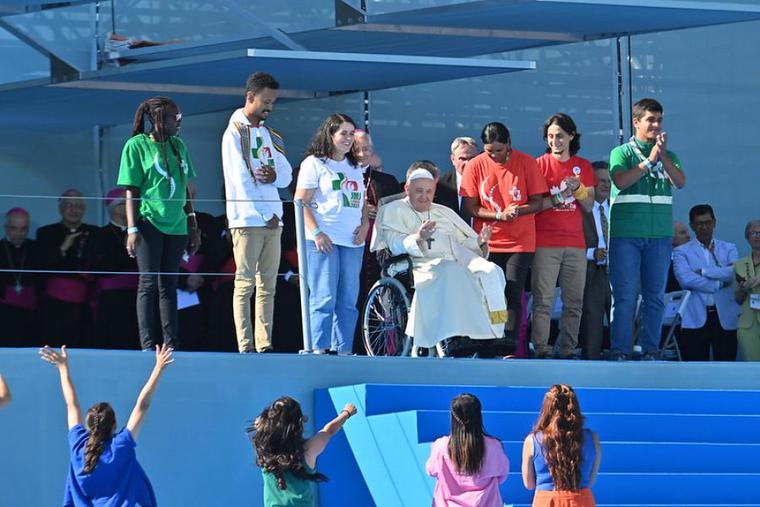 Young people greet Pope Francis as he arrives at the World Youth Day welcoming ceremony in Lisbon, Portugal, Aug. 3, 2023.