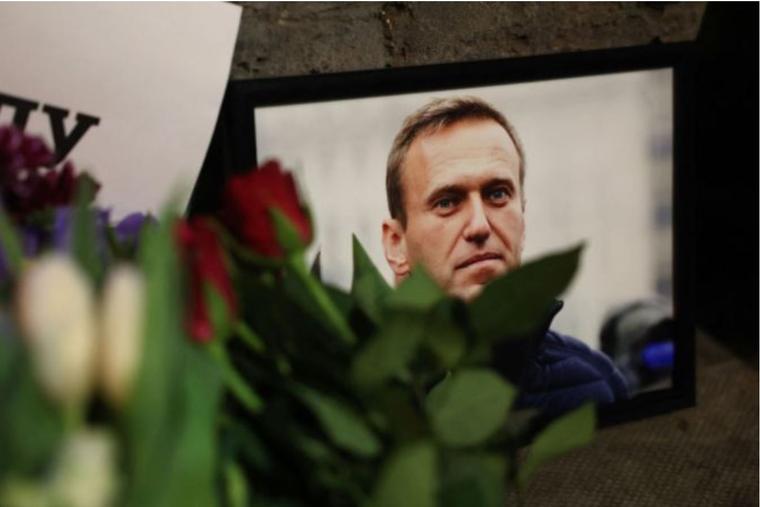 Photographs and flowers are left outside the Russian Embassy in London on Feb. 16, following the news of the death of Russian opposition leader Alexei Navalny.