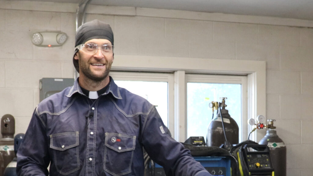 Priest and welder