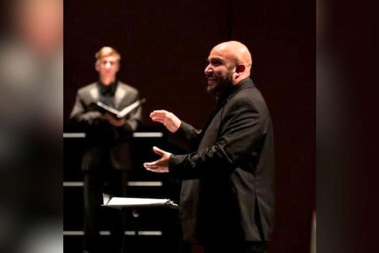 Richard Carrillo, composer of “Requiem for the Forgotten,” conducts a choir. Carrillo is finishing his doctorate in choral conducting at the Frost School of Music at the University of Miami.