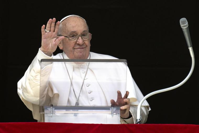 Pope Francis waves to pilgrims gathered in St. Peter’s Square during his Sunday Angelus on March 17.