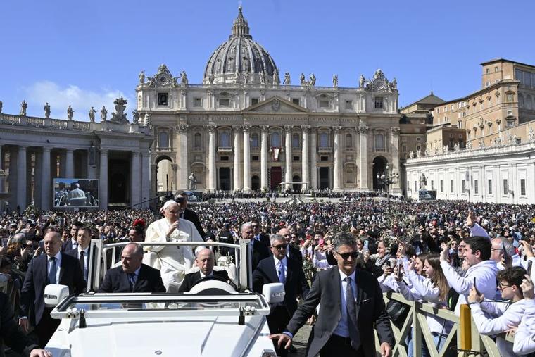 Pope Francis waves after Palm Sunday Mass 2024.