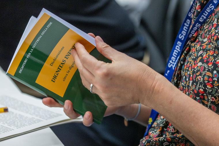 Attendees peruse the new document during a press conference at the Vatican April 8, 2024.