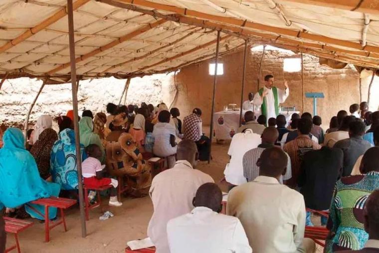 A priest celebrates Mass in Sudan before the outset of war.