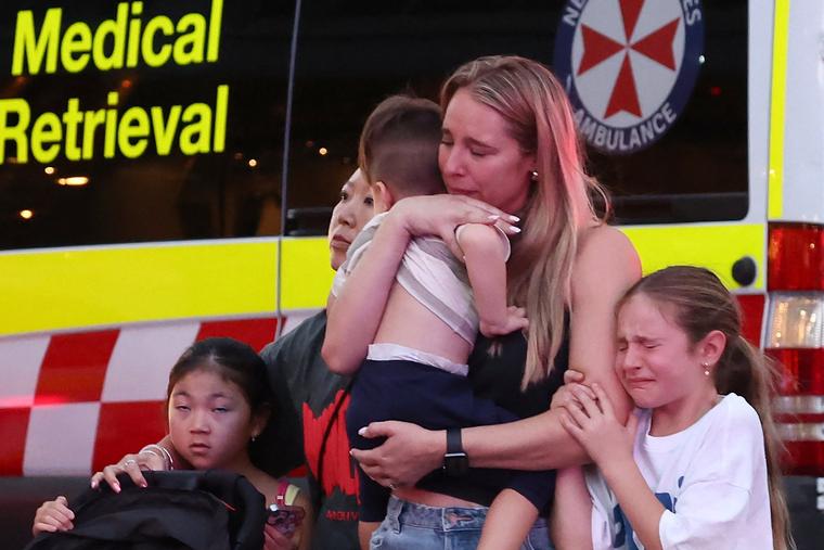 Families leave the Westfield Bondi Junction shopping mall after a stabbing incident in Sydney on April 13.
