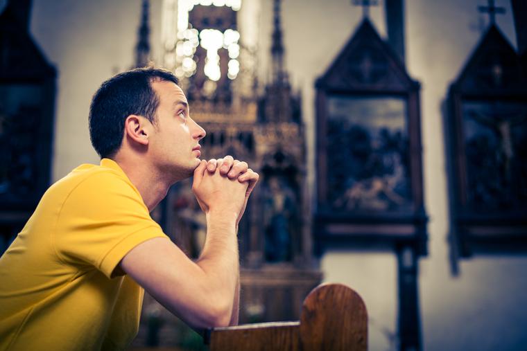 A man prays during adoration.
