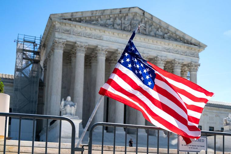 An American flag blows in the breeze outside the US Supreme Court on April 16, 2024 in Washington, DC.
