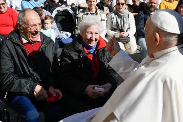 Pope Francis greets an elderly couple at a general audience in St. Peter's Square at the Vatican.