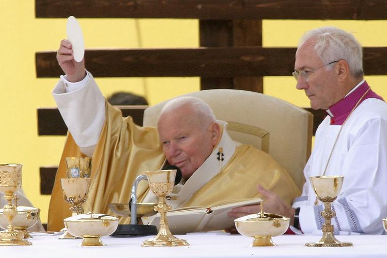 Pope John Paul II prepares Communion during an outdoor Mass he celebrated on September 13, 2003 in the town of Roznava, Slovakia.