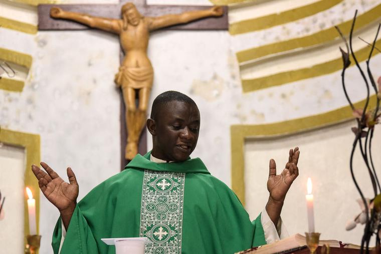 Father John Nat Tucker leads a service at the Saint Paul Catholic Church in Freetown.
