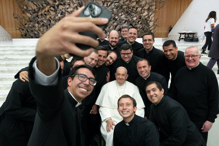 Pope Francis poses with priests for a selfie during his weekly audience at the Paul VI Hall on May 01, 2024 in Vatican City, Vatican.