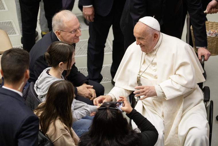 Pope Francis greets the faithful inside Paul VI Hall at the Vatican during his May 1 general audience.
