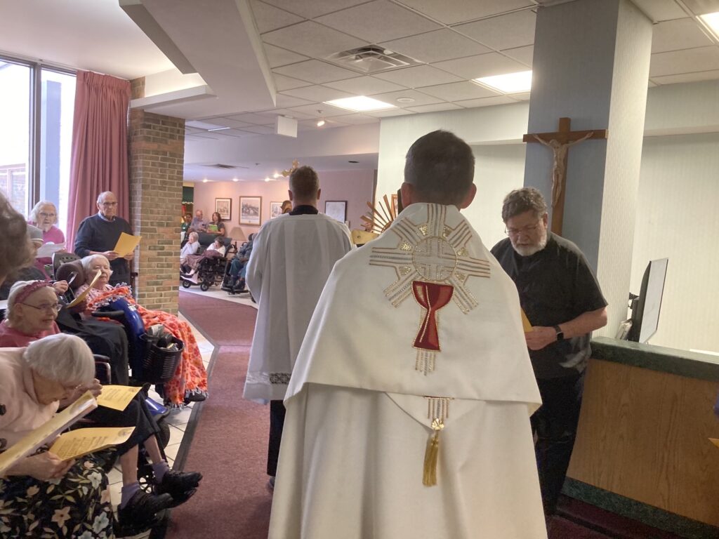 Deacon Joseph Michalak 2 and 3: deacon brings in Eucharist past resident “honor guard “