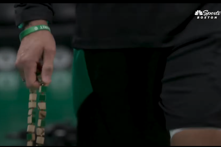 Boston Celtics head coach Joe Mazzulla prays the Rosary walking along the court at TD Garden. The beads are much larger than usual because they are specially made from pieces of wood taken from the former floor of the Garden that has been discarded.