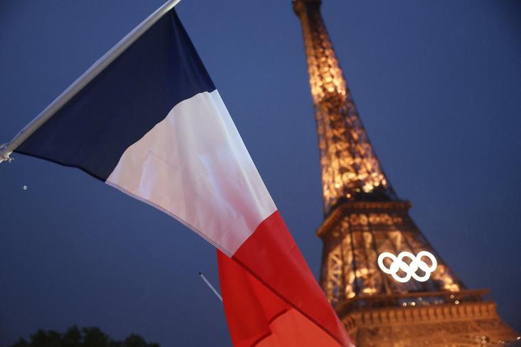 The French flag is pictured from the boat of the Freench delegation below the Eiffel Tower on the River Seine during the Opening Ceremony of the Paris 2024 Olympic Games on July 26.