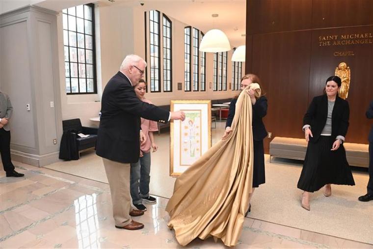 A drawing of the Crucifixion by imprisoned Catholic and pro-democracy activist Jimmy Lai is unveiled by Lai's godfather, William McGurn, and Lai’s wife and daughter at The Catholic University of America in Washington, D.C., Feb. 22.