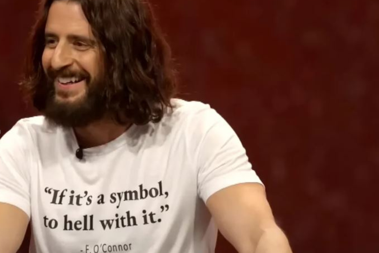 Catholic actor Jonathan Roumie wears his Eucharistic-quote T-shirt while addressing the National Eucharistic Congress on July 20.