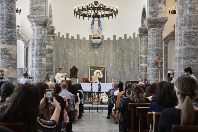 The faithful celebrate Mass in the 80-year-old Chaldean Catholic Church of Um al-Mauna, ‘Our Lady of Perpetual Help,’ in Mosul in northern Iraq on April 5. With chants and joyous ululations, Iraqi Christians celebrated the restoration of the church on April 5, years after jihadists turned it into a religious police office.