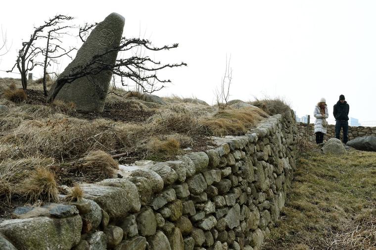 Tourists walk near the Irish Hunger Memorial located in Battery Park in Lower Manhattan. The Irish Hunger Memorial (or Irish Famine Memorial), the creation of artist Brian Tolle, is a monument and a garden dedicated to those who perished during the Great Irish Famine and Migration of 1845-1852.