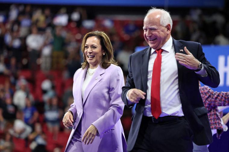 Vice President and Democratic presidential candidate Kamala Harris (L) and Minnesota Governor and Democratics vice presidential candidate Tim Walz gesture during a campaign rally at the Thomas and Mack Center, University of Nevada in Las Vegas, Nevada, on August 10, 2024.