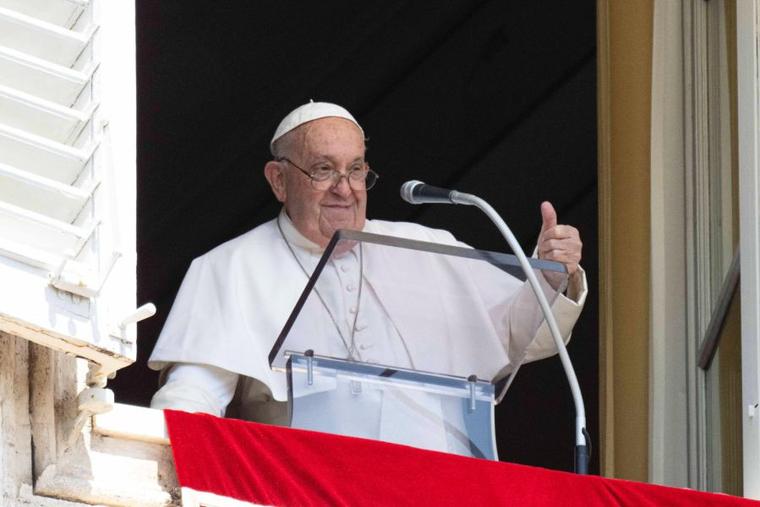 Pope Francis gives a thumbs-up to pilgrims at the Vatican during the Sunday Angelus, Aug. 11.