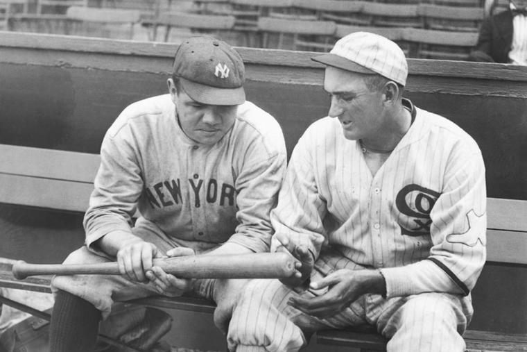 Babe Ruth and Shoeless Joe Jackson looking at one of Ruth's home run bats, 1920.