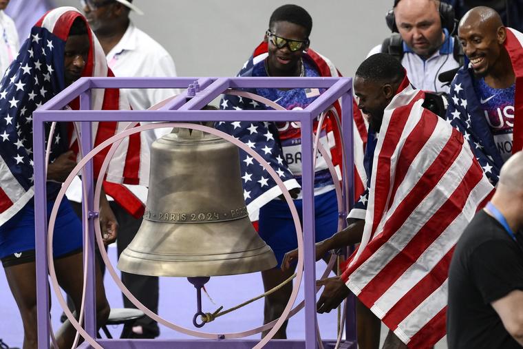 U.S. Olympians Christopher Bailey, Bryce Deadmon, Rai Benjamin and Vernon Norwood ring the bell after winning gold in the men's 4x400-meter relay final during the Paris 2024 Olympic Games.