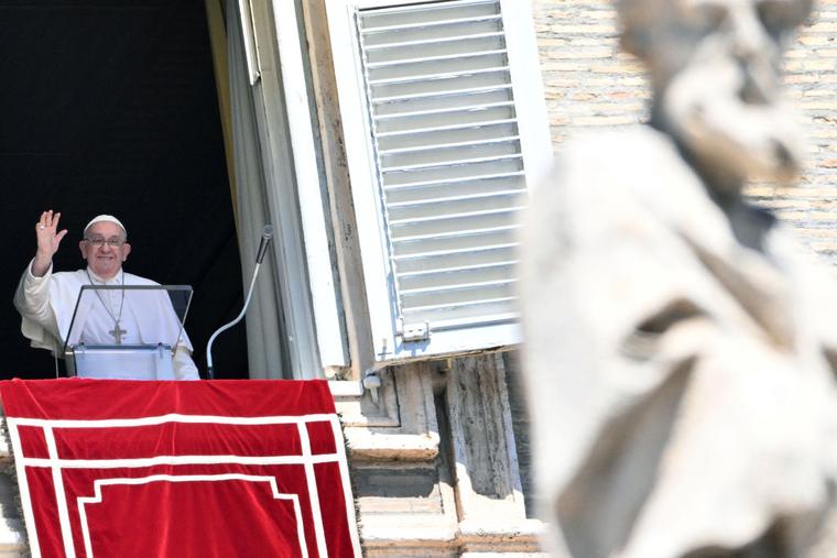 Pope Francis delivers his blessing during the Angelus prayer from the window of the Apostolic Palace overlooking St. Peter's Square, during the Angelus prayer at the Vatican on August 25, 2024.