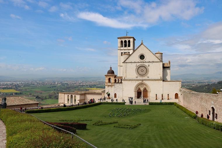 The Basilica of St. Francis stands over the countryside surrounding Assisi, Italy.