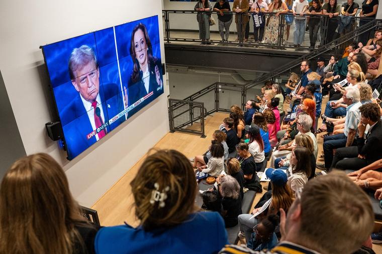 People watch the Sept. 10 presidential debate between former U.S. president and Republican nominee Donald Trump and U.S. Vice President and Democratic candidate Kamala Harris in Nashville, Tennessee.