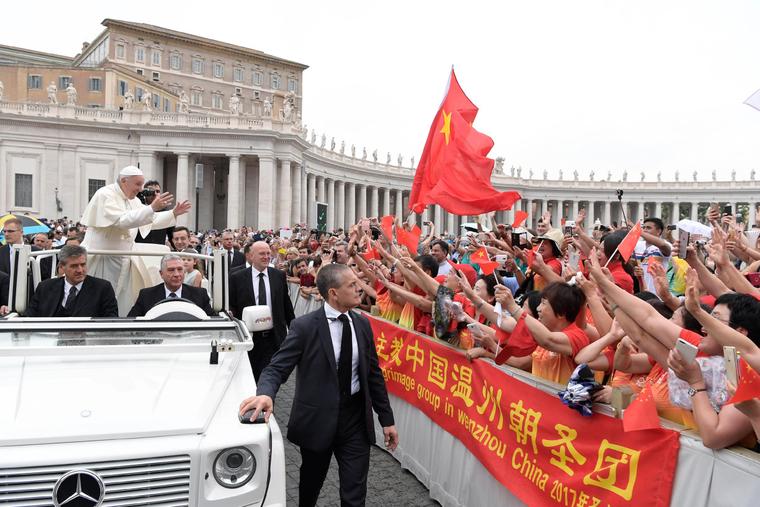 Pope Francis waves to pilgrims from China at the general audience in St. Peter's Square on June 28, 2017.