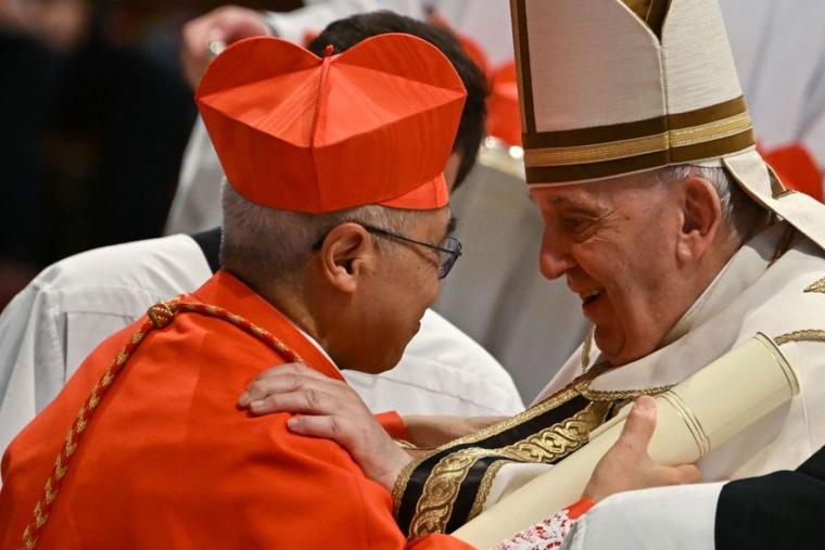 Pope Francis speaks to Archbishop William Seng Chye Goh (left) after he elevated him to cardinal during a consistory to create 20 new cardinals on Aug. 27, 2022, at St. Peter’s Basilica at the Vatican.