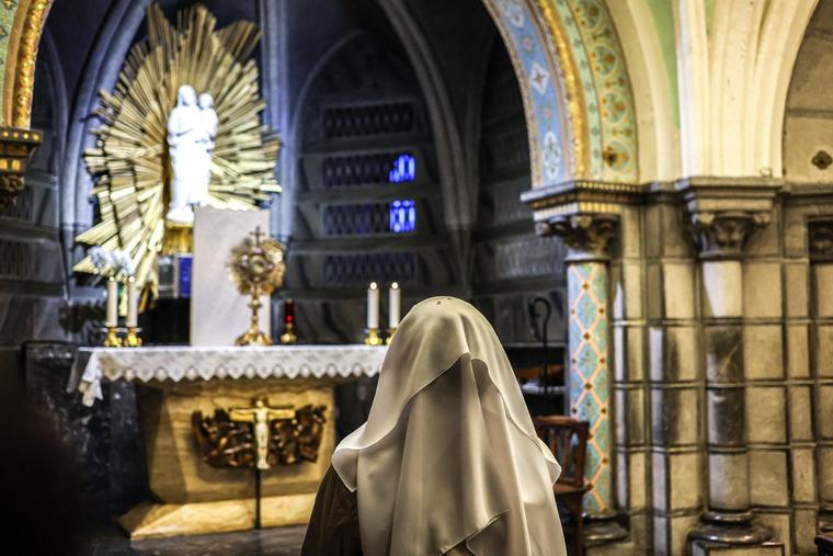 A nun prays in the Crypt of the Basilica of the Immaculate Conception at the Sanctuary of Lourdes, in Lourdes, southwestern France, on Nov. 8, 2022.