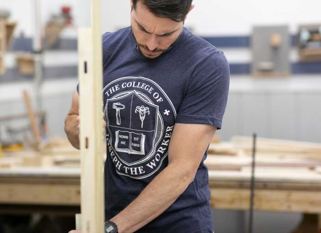 The College of St. Joseph the Worker logo