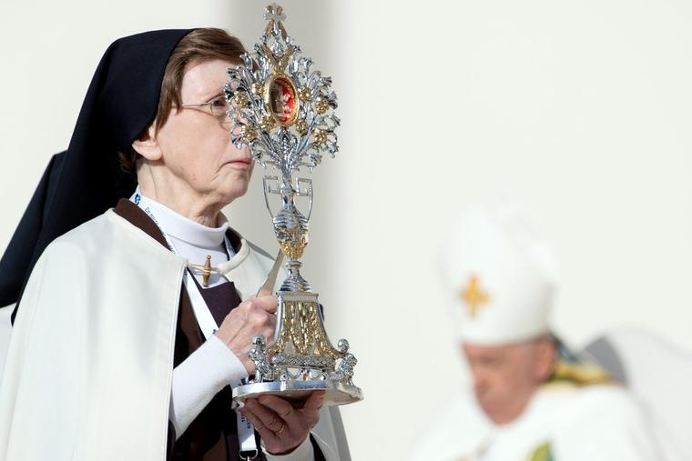 A Carmelite sister carries a relic of Blessed Anne of Jesus at the beatification Mass Sunday at King Baudouin Stadium in Brussels.