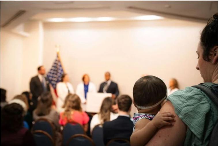 A young spectator watches as doctors announce the Women’s Health Declaration at a press conference on Oct. 22, 2024, in Washington, D.C.