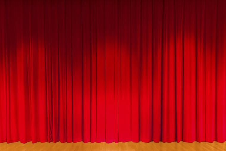 MUNICH, BAVARIA, GERMANY - 2014/11/25: A curtain in dark red color, covering a theater stage.