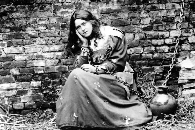 St. Thérèse of Lisieux poses in a costume of St. Joan of Arc in the 1880s. Joan of Arc was declared a saint in 1920 — and five years after that, so was the Little Flower.