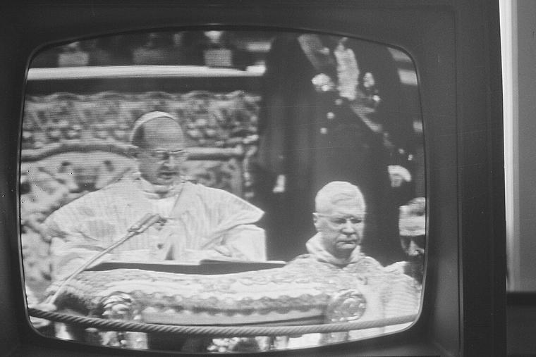 Pope St. Paul VI speaks during the Second Vatican Council as seen from this television screen.